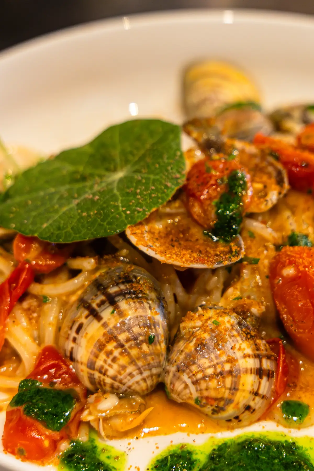 Close-up of clam pasta with cherry tomatoes and herb oil at Acqua e Sale