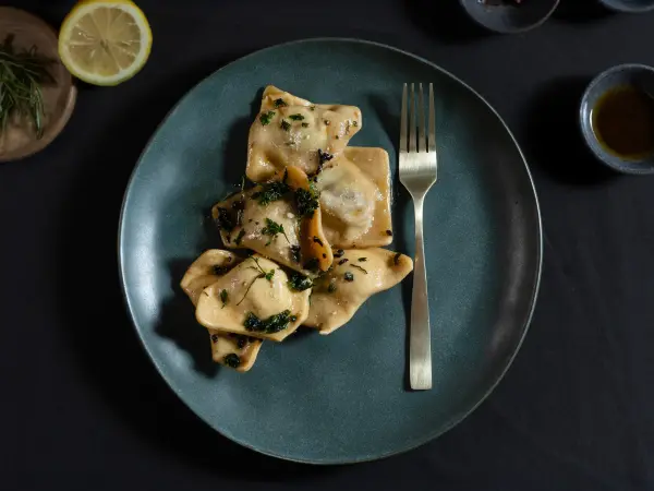 Beef cheek ravioli plated for a fine dining menu, professional food photography in Perth.