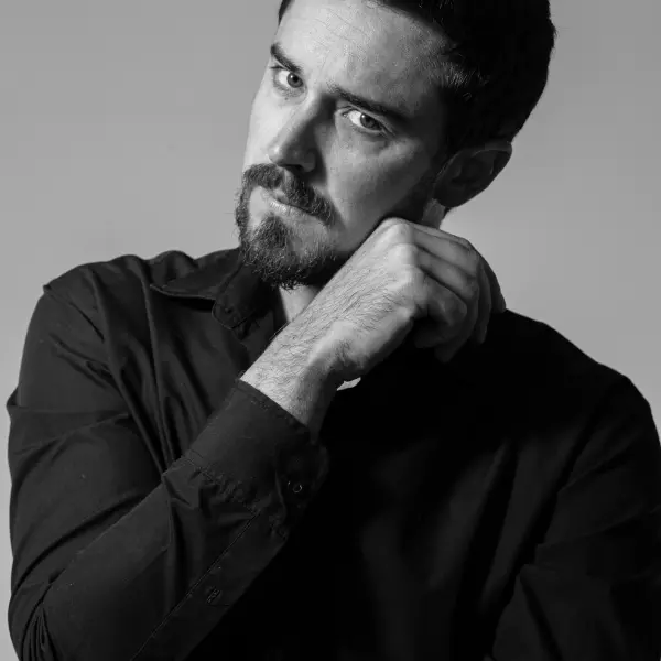 Black-and-white male portrait created with calm studio direction.