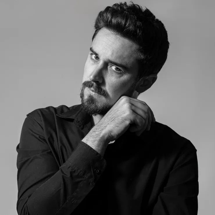 Dramatic black and white studio portrait of a man, showcasing professional lighting and headshot photography in Perth.