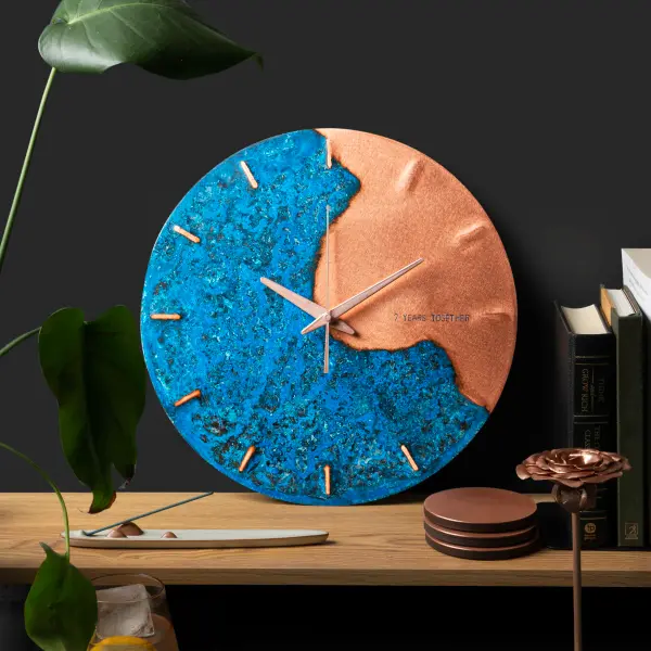 Blue and gold wall clock on white background, clean packshot product photography for online stores.
