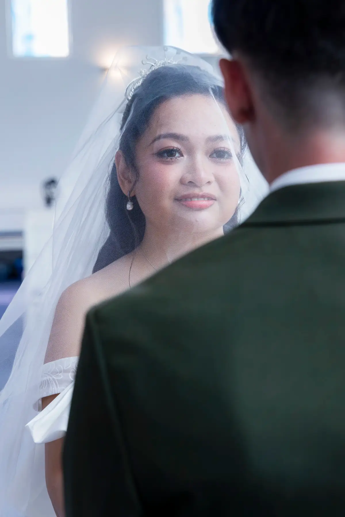 Bride photographed through her veil during the wedding ceremony at Pater Noster Catholic Church