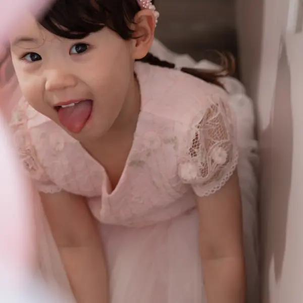 Child smiling during a candid birthday party portrait.