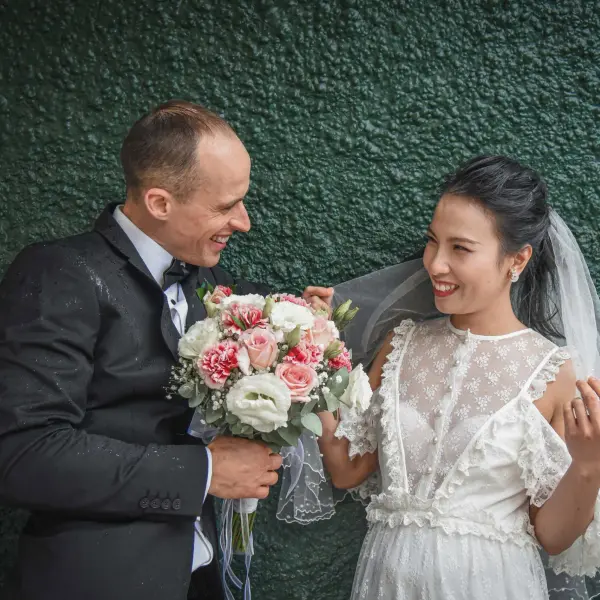 Wedding couple laughing together in a candid portrait.