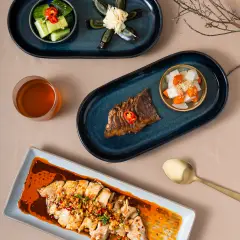 Flatlay of century egg and beef appetizers, organized menu photography for Perth Chinese cuisine website design.