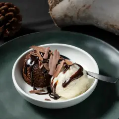 Molten chocolate lava cake with vanilla ice cream, high-contrast dessert photography for Perth restaurant menu and marketing.