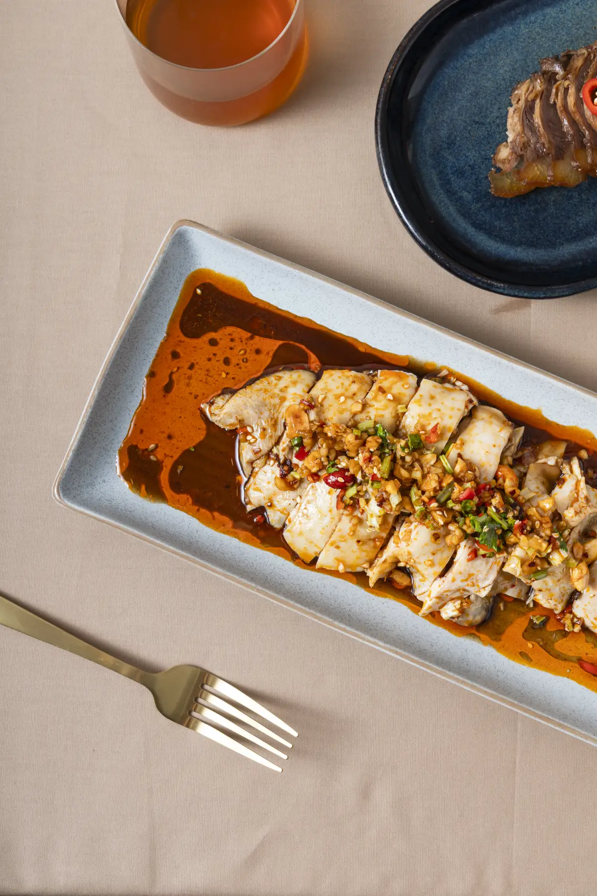 Sliced fish dish plated in chilli sauce for the Como Garden seasonal menu