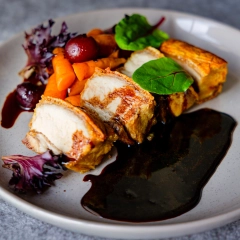 Plated crispy pork belly with rich jus, fine dining food photography for Perth hospitality brand identity and website.