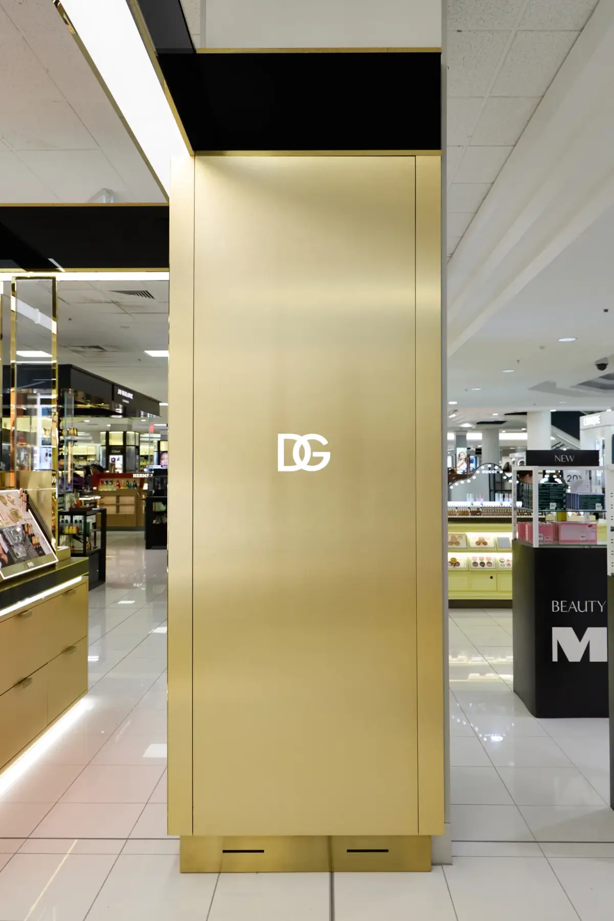 Brushed gold Dolce&Gabbana pillar with the white DG monogram inside the Myer Perth beauty hall