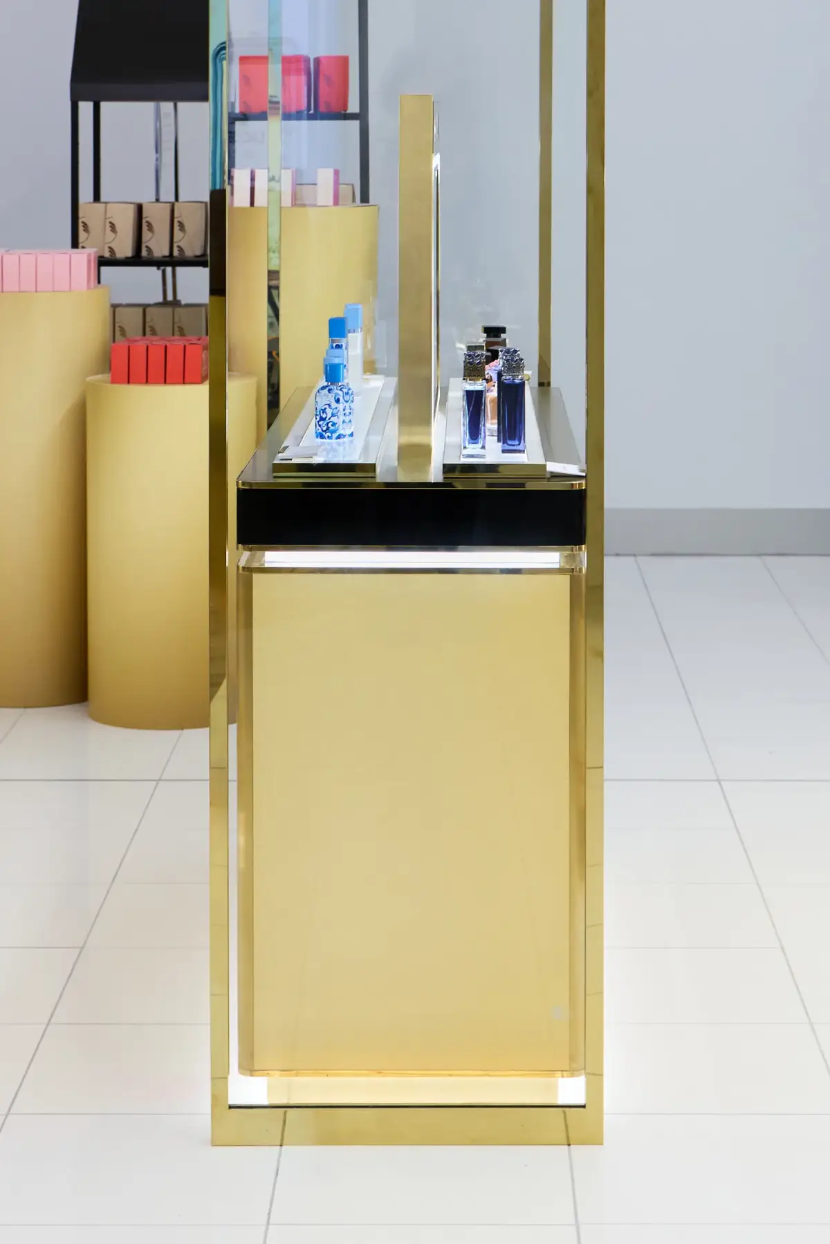 Detail view of the Dolce&Gabbana fragrance counter at Myer Perth showing gold and black joinery with Light Blue and perfume bottles on a glass shelf