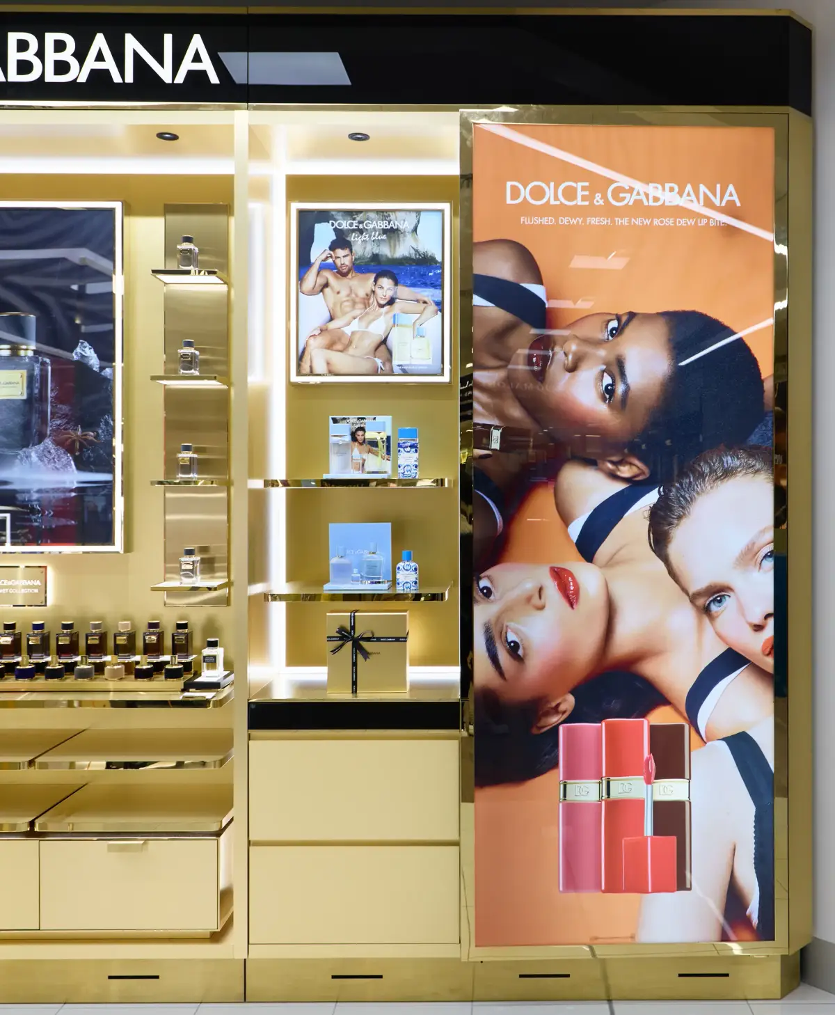 Dolce&Gabbana campaign panels at Myer Perth showing the Light Blue fragrance artwork and the Rose Dew lip campaign beside gold shelving