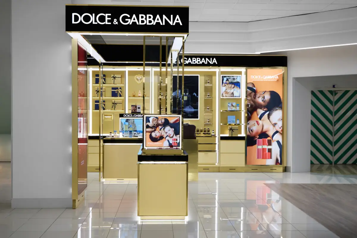 Dolce&Gabbana Beauty concession entrance at Myer Perth showing illuminated black signage above the gold fitout and gloss white tiled floor