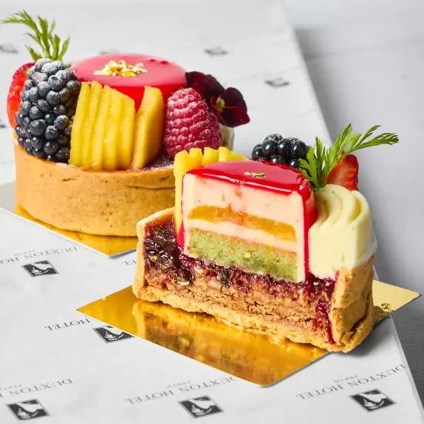 A berry tart and layered cake photographed for cafe photography in Perth.