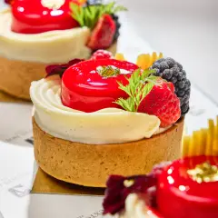 Berry tart with glossy red glaze, cream, blackberries, raspberries, and mango photographed for Duxton Hotel Perth patisserie content.