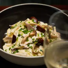 Creamy mushroom pasta with chives and garnish photographed in a close restaurant menu style for Duxton Hotel Perth.
