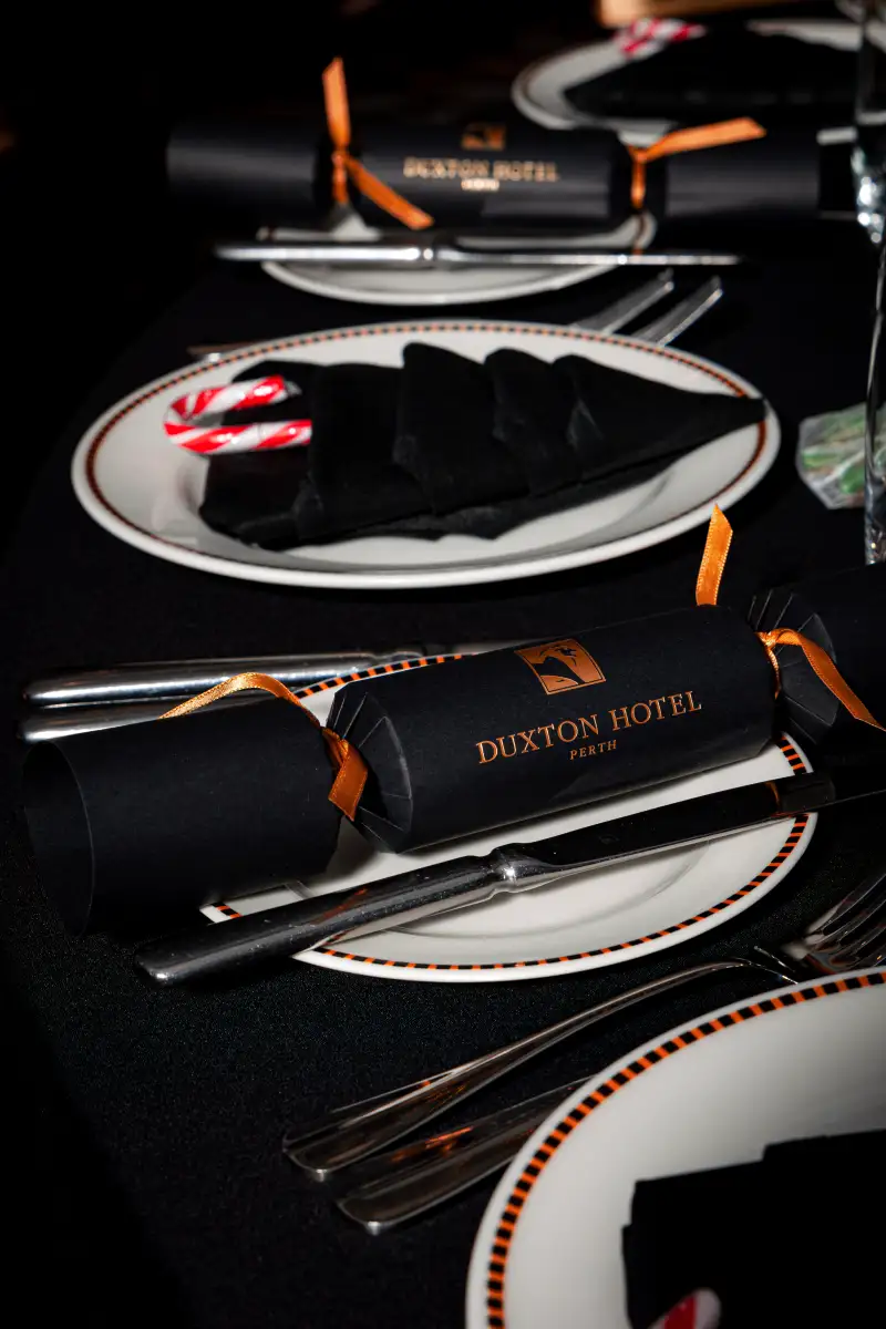 Black napkin and menu place setting at a gala dinner