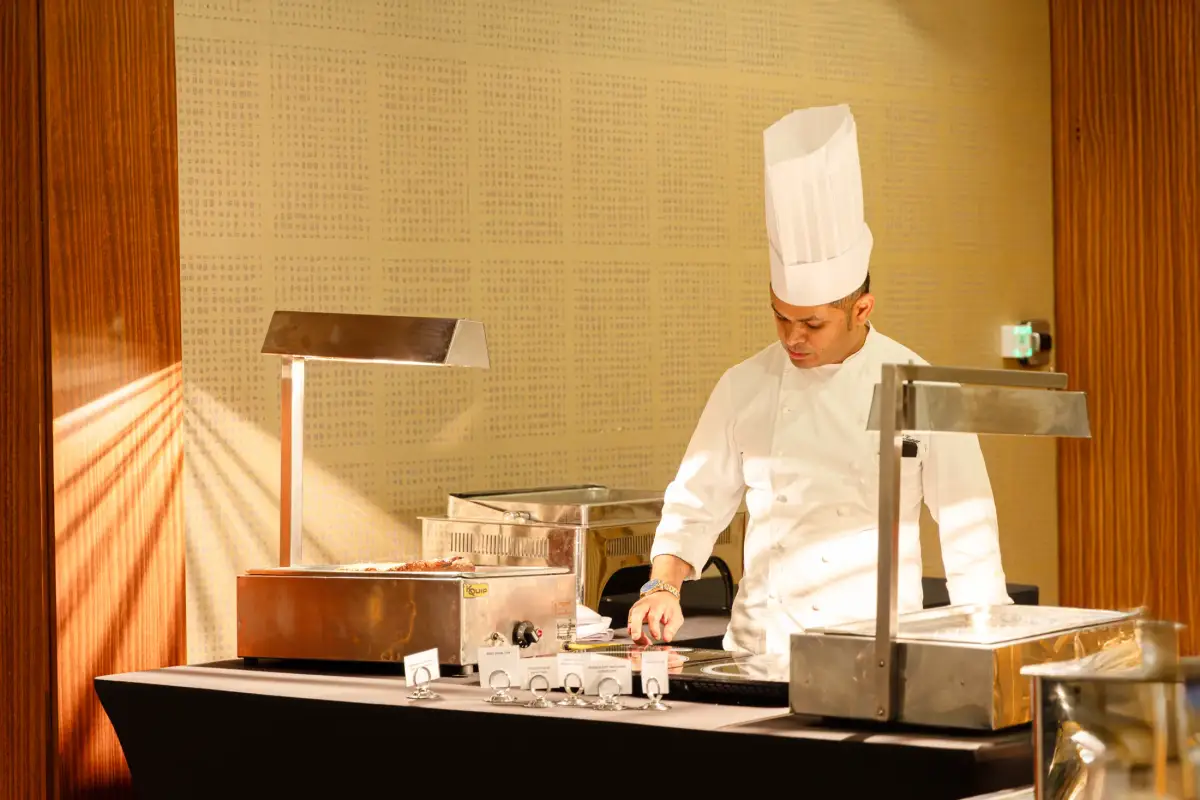 Chef operating a live buffet station during a festive event at Duxton Hotel Perth