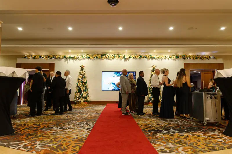 Guests arriving on the red carpet at a formal event