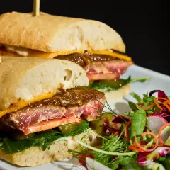 Steak sandwich with toasted bread, greens, and sliced beef photographed for Duxton Hotel Perth hospitality marketing.