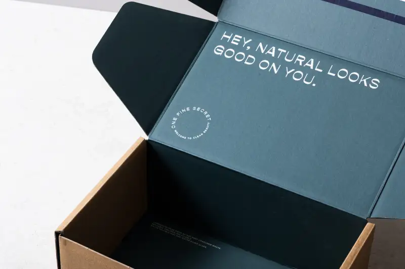 Open sustainable shipping box showing packaging construction and branded details.