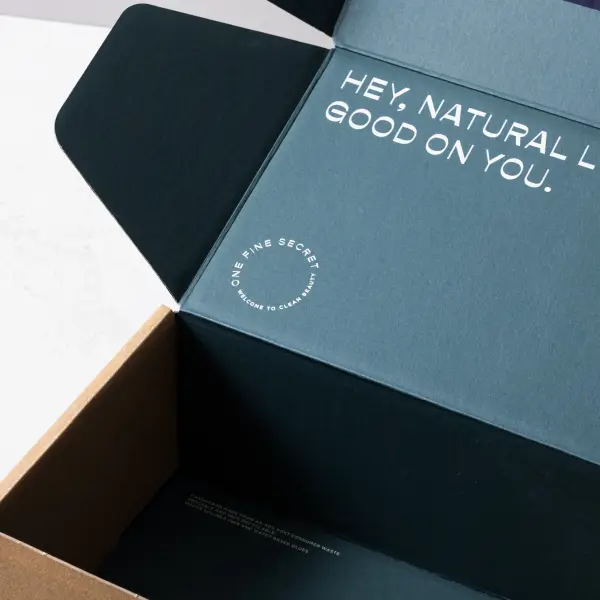 Open sustainable shipping box showing packaging construction and branded details.