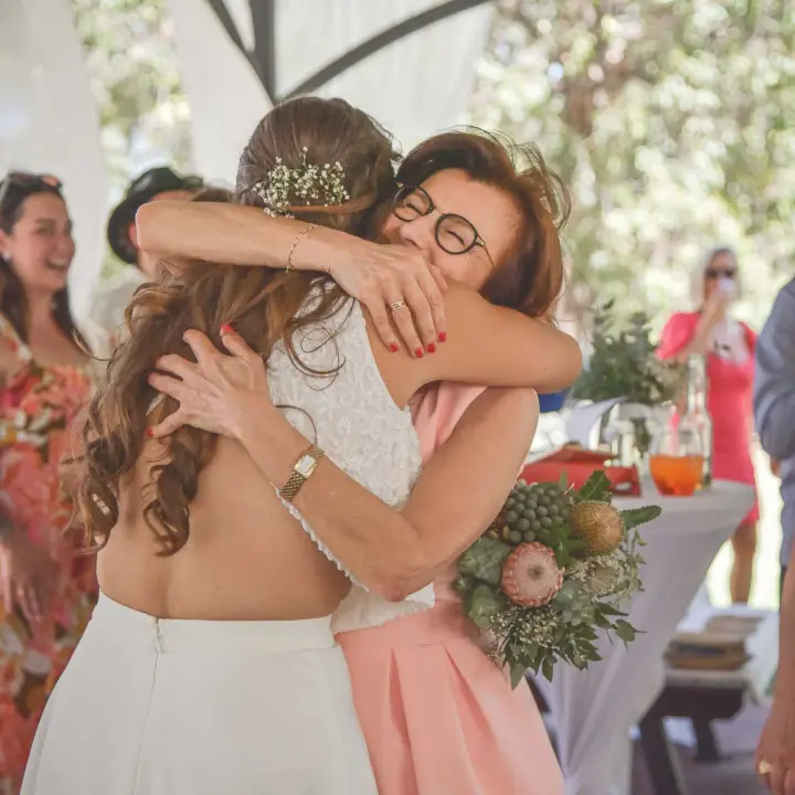 Emotional wedding guest hug captured during a Perth celebration.