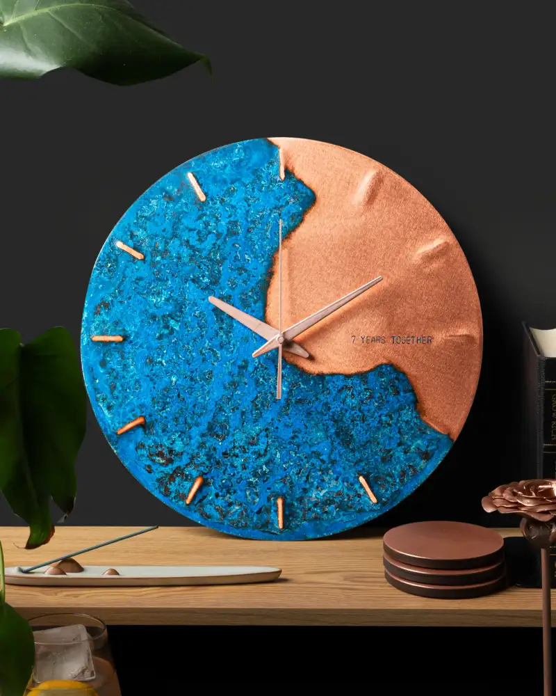 Empire Copper wall clock styled on a shelf for a product detail page.