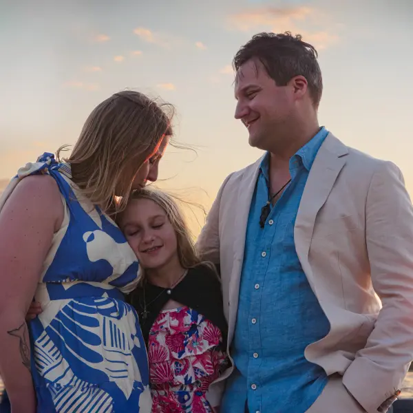 Family sharing an affectionate moment during a sunset portrait session in Perth.