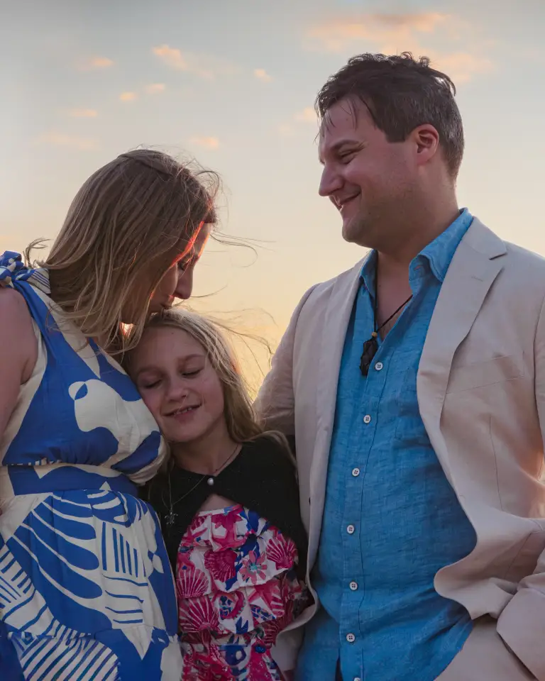Family sharing an affectionate moment during a sunset portrait session in Perth.