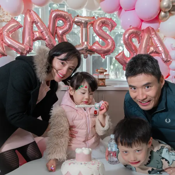 Family gathered around a birthday cake at a private Perth celebration.