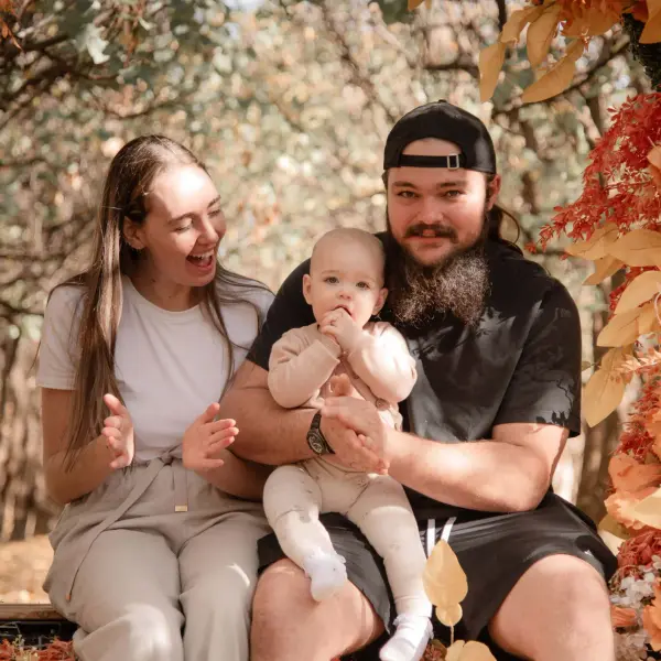 Family portrait beneath an autumn floral arch in Perth.