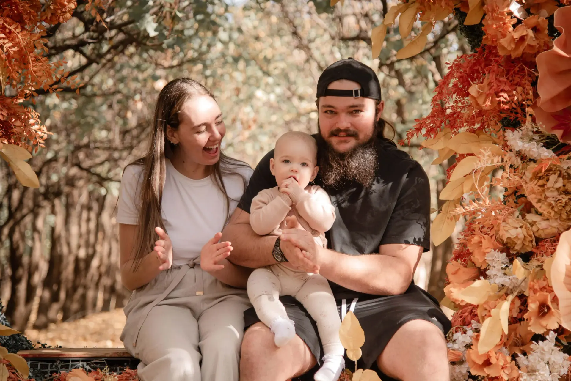 Perth family portrait session with an autumn floral setting and a close mother-and-baby moment.