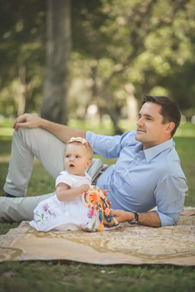 Father and daughter together during an outdoor family portrait session.