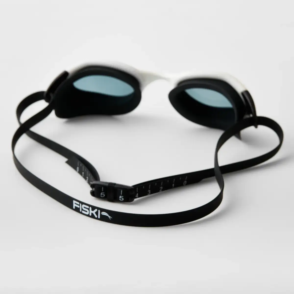 Rear view of Fiski swimming goggles showing the silicone gasket and adjustable strap.