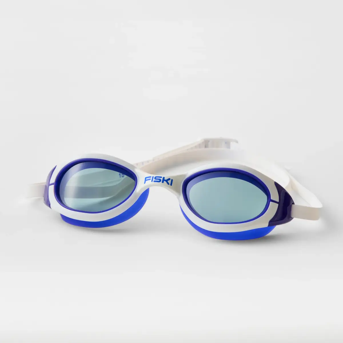 White and blue Fiski swimming goggles with blue tinted lenses showing the numbered strap adjustment markings