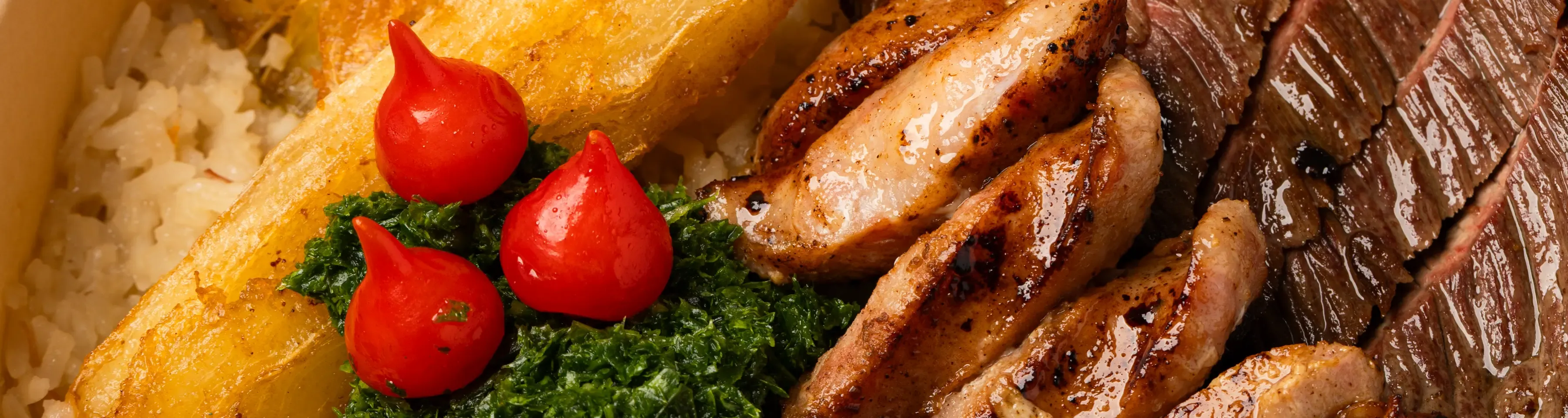 Close-up macro shot of sliced steak, roasted potatoes, and garnishes for a restaurant menu.