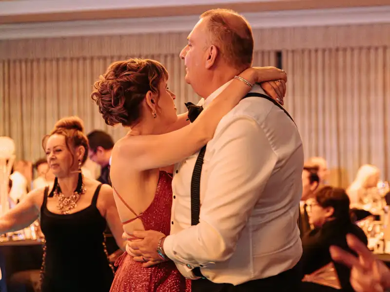 A couple in formal attire dancing at a gala event, symbolizing the vibrant atmosphere a ranked venue can attract.