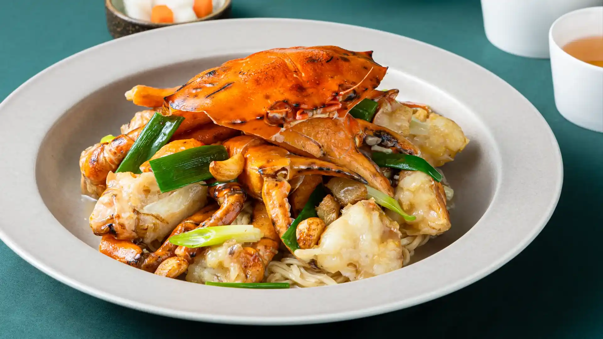 Vibrant stir-fried crab with ginger and noodles, captured during a commercial food photography shoot in Perth.