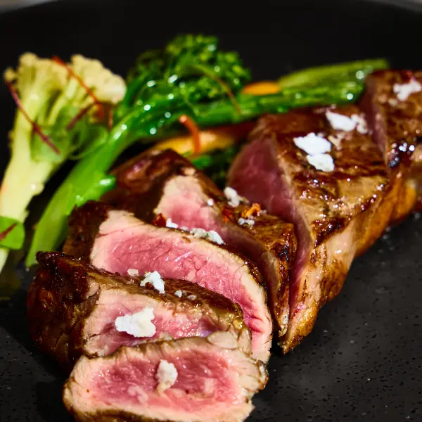 Grilled steak with broccolini photographed as a restaurant dish in Perth.