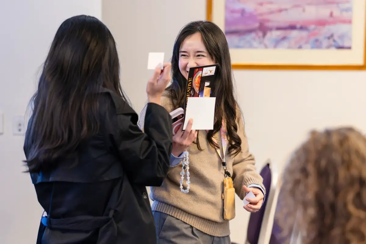 Delegates exchanging business cards during exhibition networking