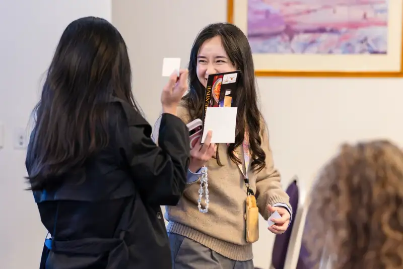 Delegates exchanging business cards during networking