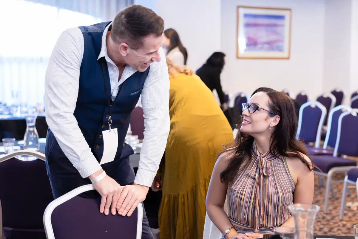 Two delegates in conversation between sessions in the Pagoda Resort conference room at the Intrigue MADVERSE Perth summit