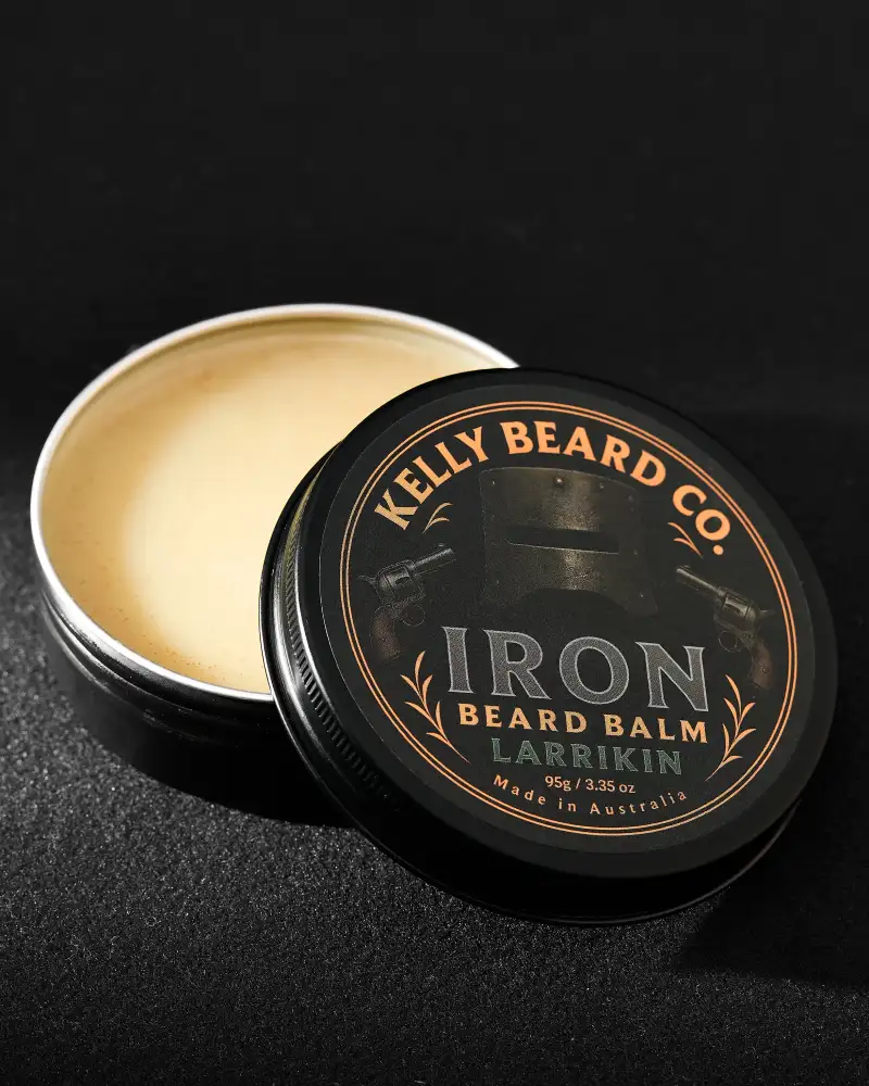 Open beard-balm tin photographed close up to show product texture.