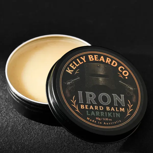 Open beard-balm tin photographed close up to show product texture.