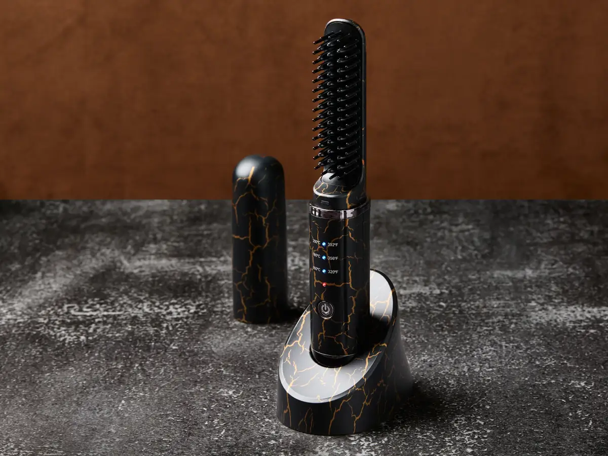 Kelly Beard Co heated beard straightener with black and gold detailing photographed on a stone surface
