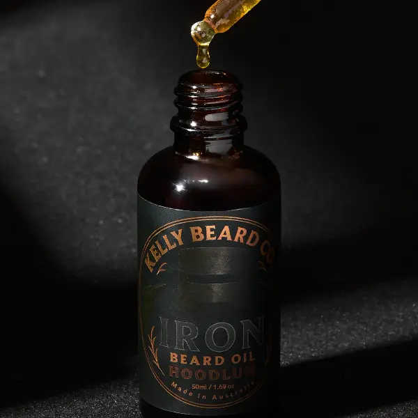 Beard-oil dropper and bottle photographed to show formula and applicator detail.