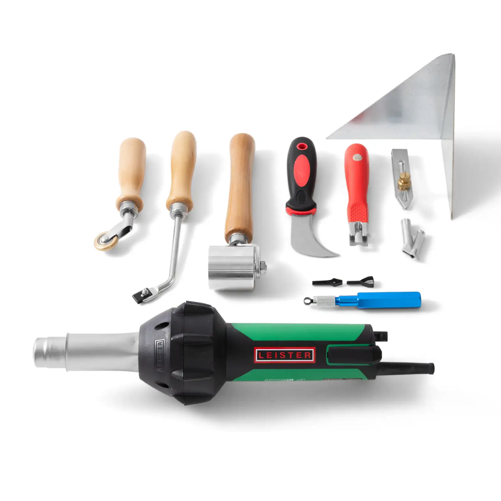 Assorted Kevmor flooring installation tools including rollers, knives, welding accessories, and a Leister heat gun arranged on white