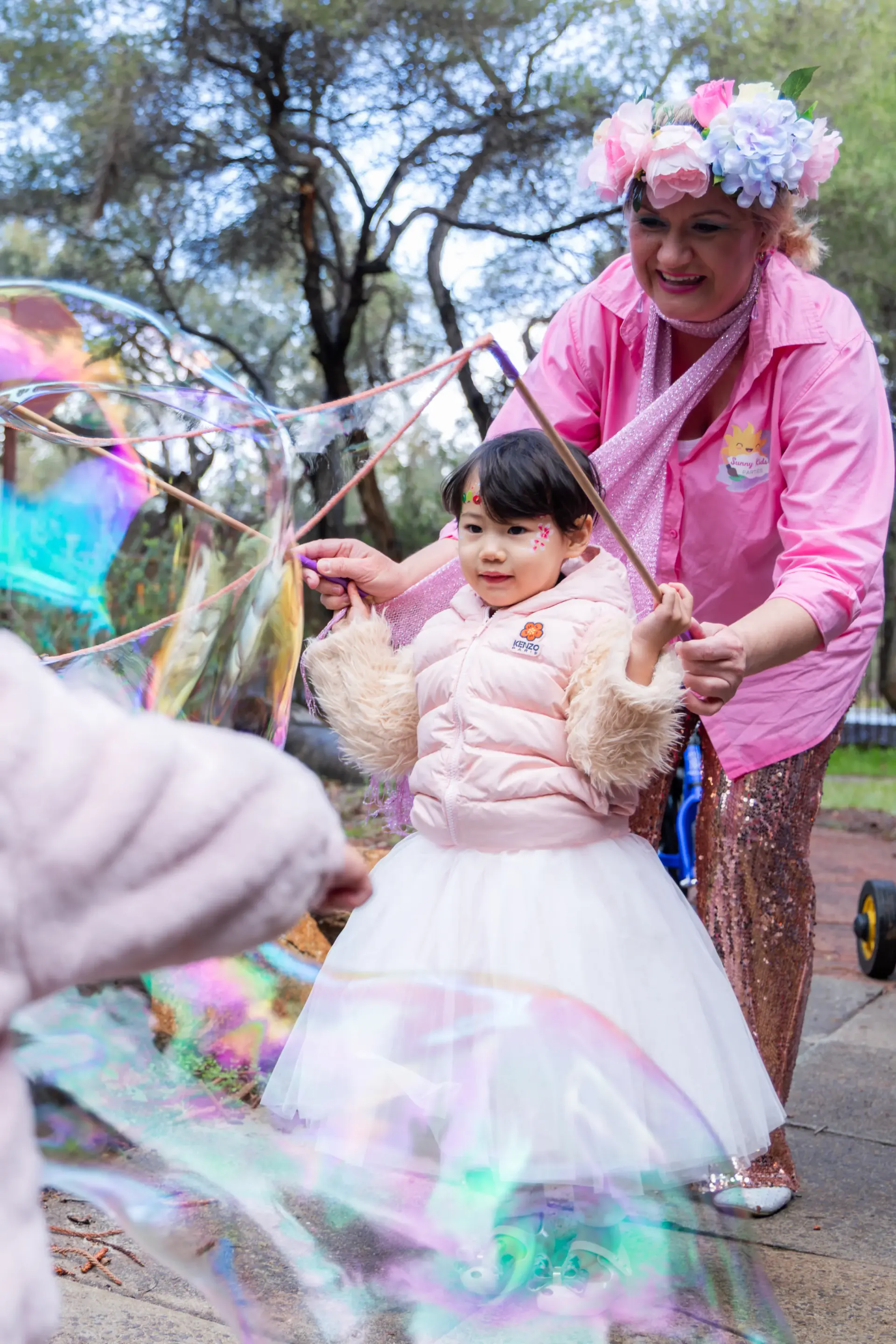 Child enjoying giant-bubble entertainment during a Perth birthday party.