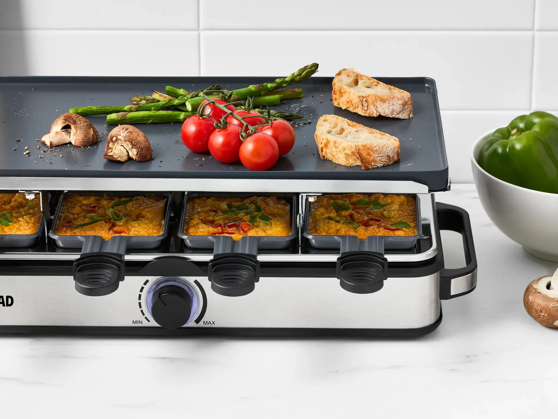 Entertainer grill photographed in use with food and serving context.
