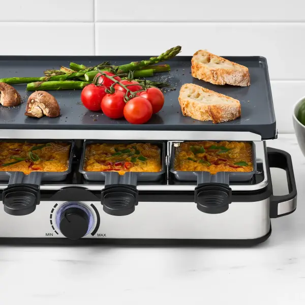 Entertainer grill photographed in use with food and serving context.